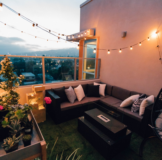 A well furnished balcony with string lights
