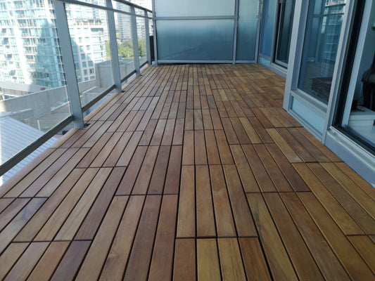 A modern glass condominium balcony with wood composite decking tiles